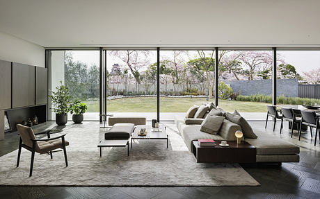 Minimalist interior with large windows and neutral tones.