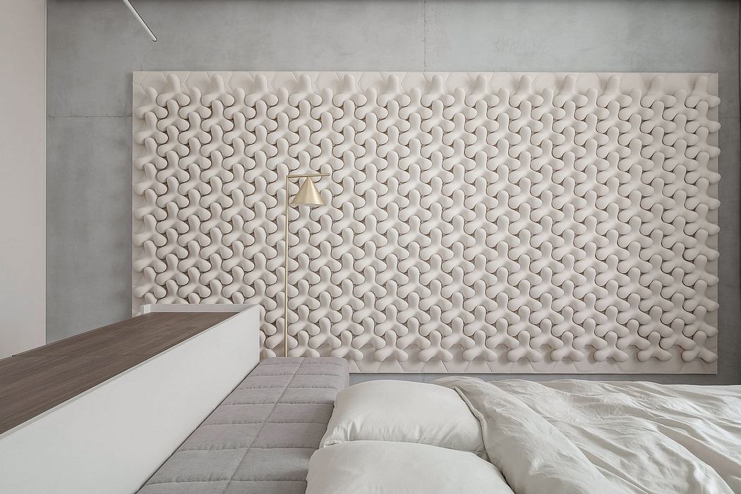 Contemporary bedroom with textured 3D wall panel and minimalist decor.