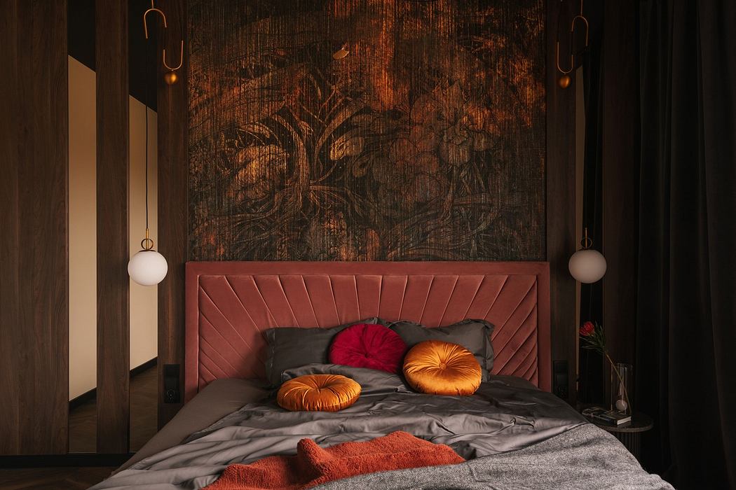 Modern bedroom with a large textured artwork above the headboard and warm-tone accents.