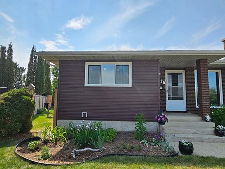 Suburban home with brown siding and neat garden.