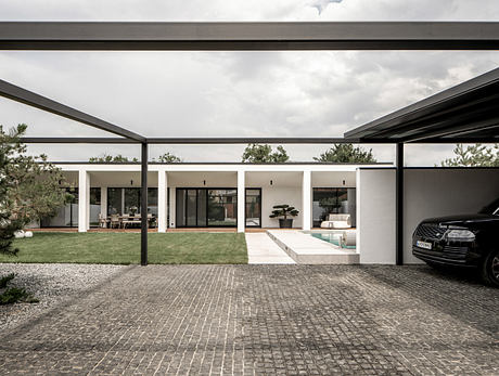 Contemporary house with flat roof and large windows.