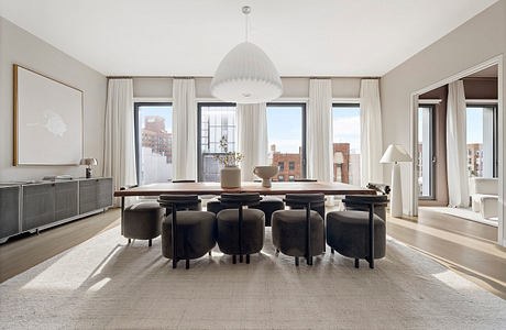 Elegant dining room with floor-to-ceiling windows, plush velvet chairs, and a modern chandelier.