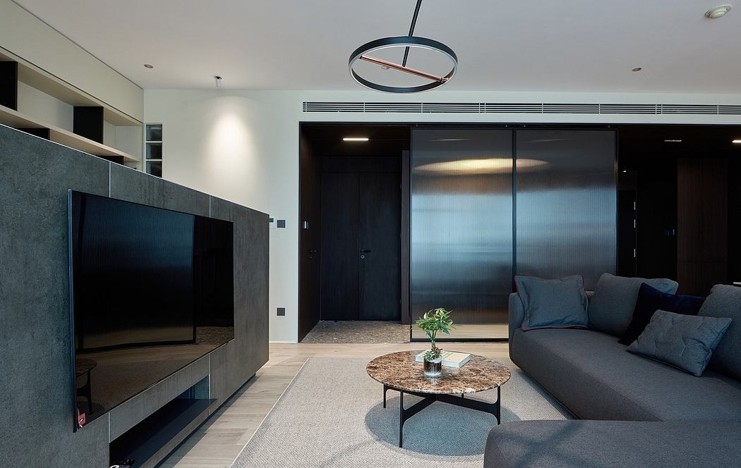 Sleek modern living room with minimalist furniture, large TV, and dramatic lighting.