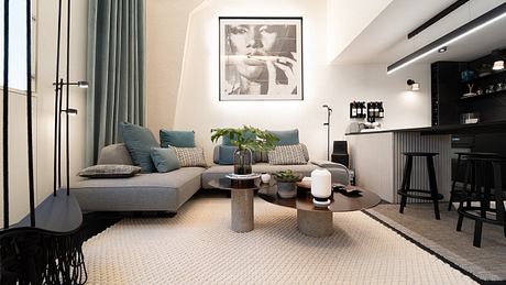 Chic living room with a gray sectional sofa, bar area, and tasteful