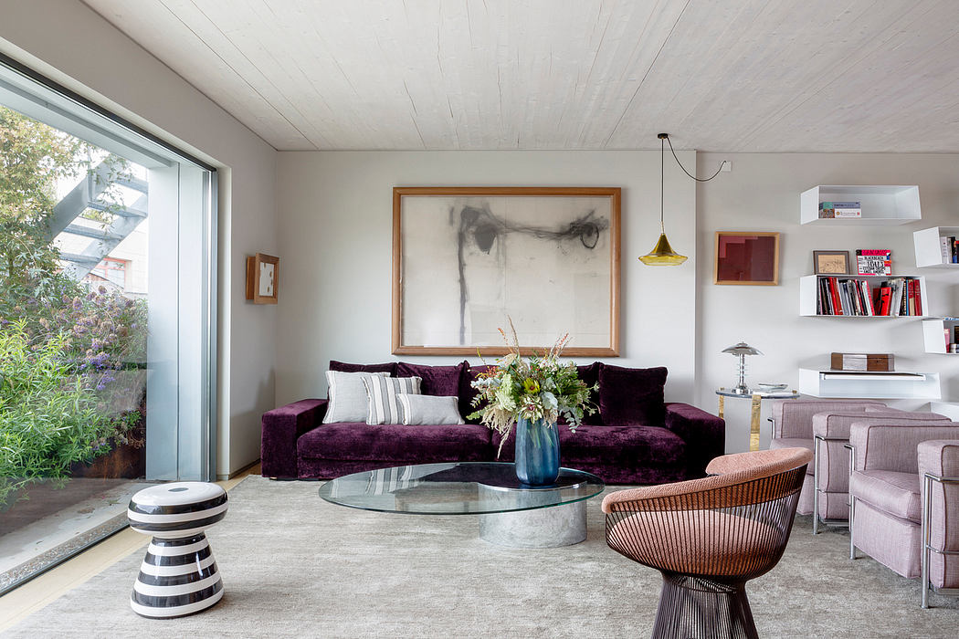 Contemporary living room with elegant purple sofa and minimalist decor.