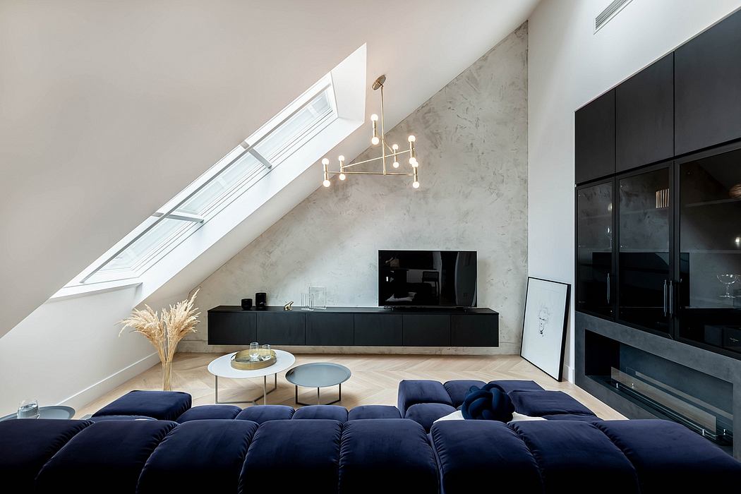 Minimalist attic living space with skylight and plush sofa.