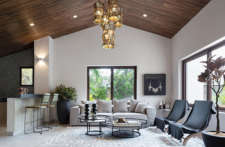 Contemporary living room with stylish furniture and unique pendant lights.