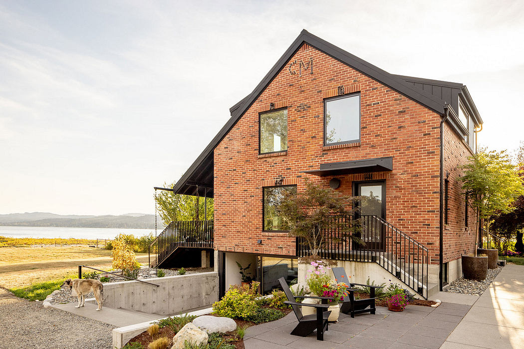 Contemporary brick home with balcony overlooking scenic landscape.