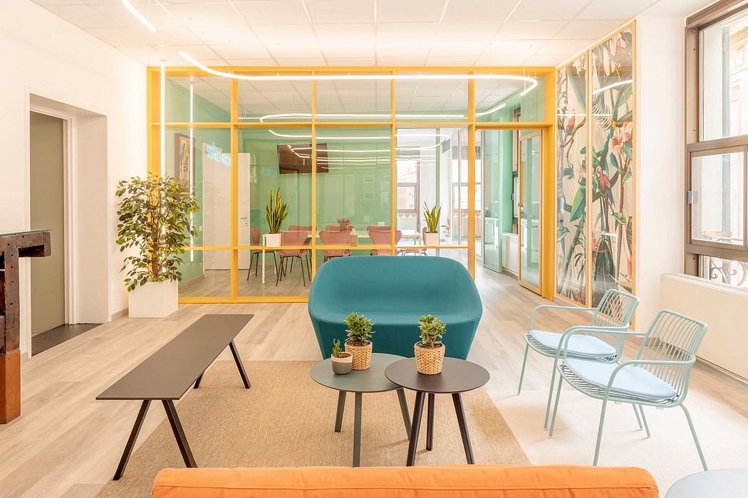 A vibrant, modern office space with colorful furniture, plants, and creative architectural elements.