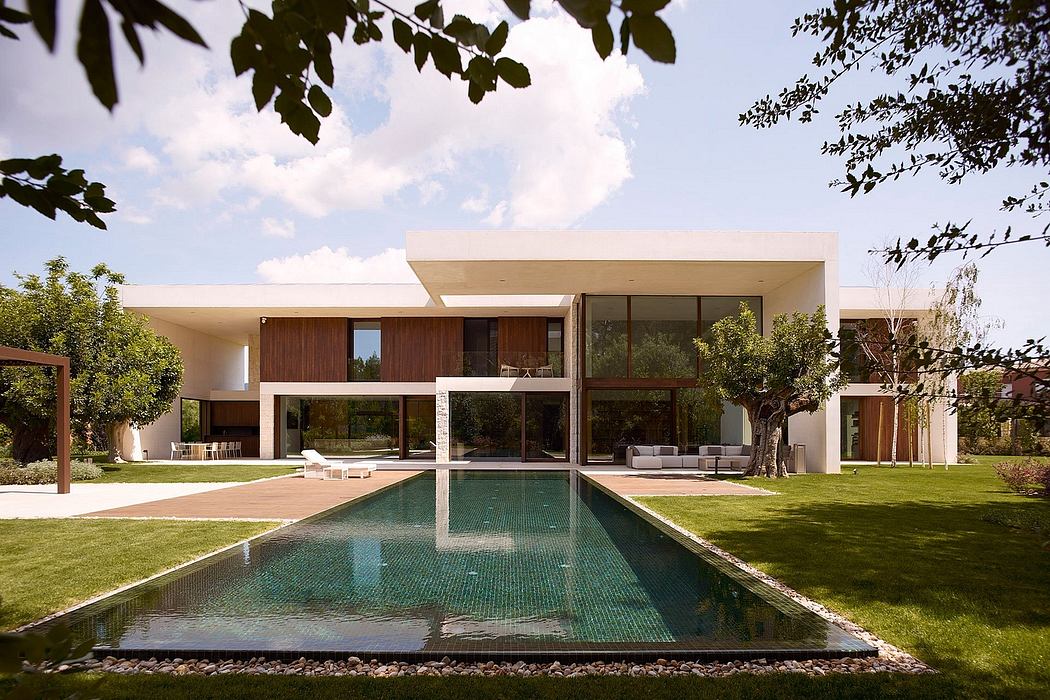 Contemporary house with pool and large windows.