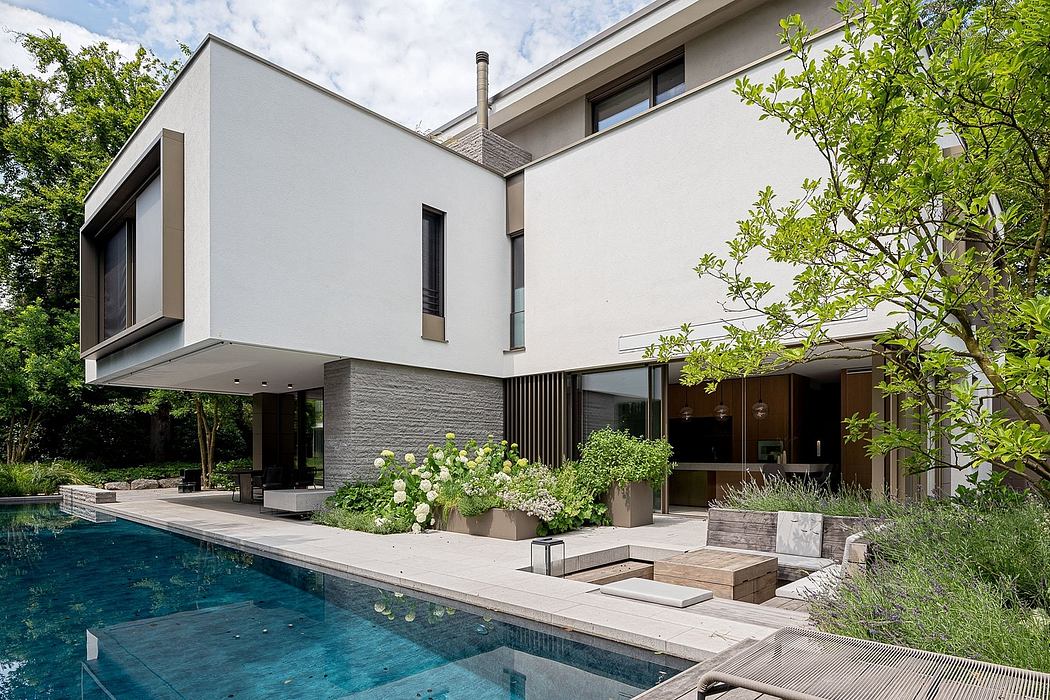 A modern, multi-level home with a sleek exterior, lush landscaping, and a tranquil pool.