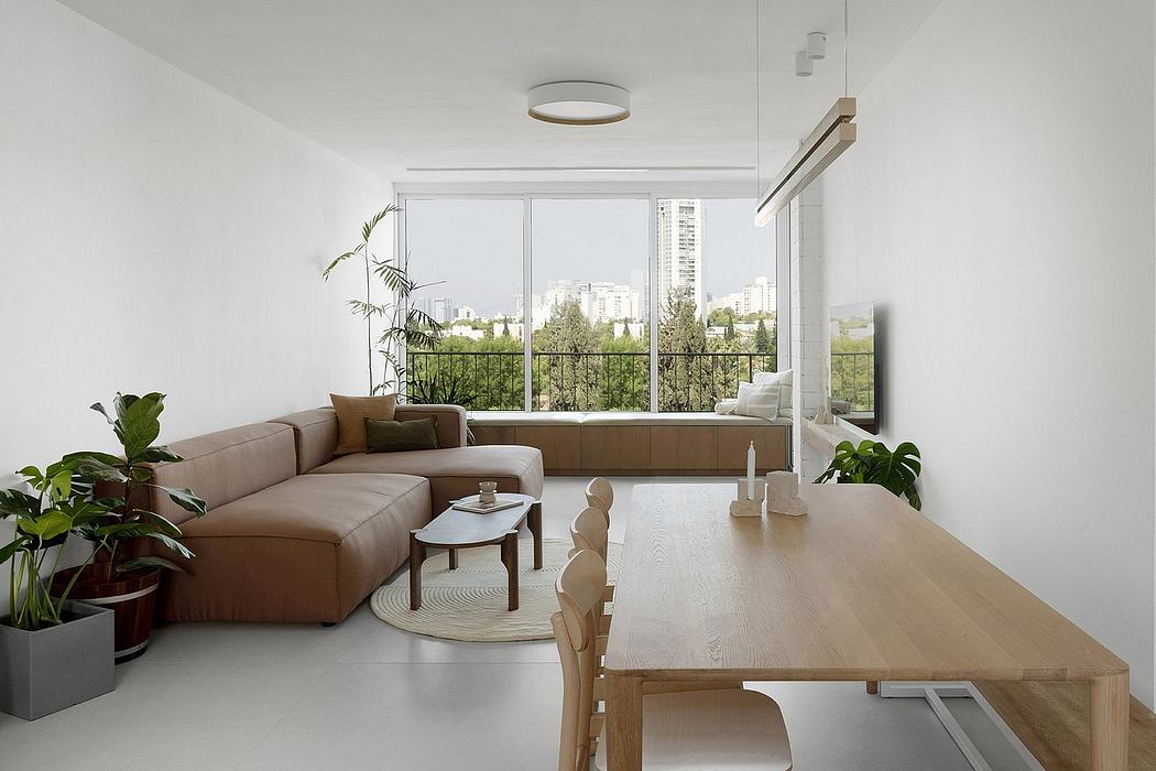 Minimalist living room with sleek furniture and large window.