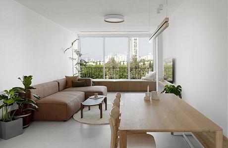 Minimalist living room with sleek furniture and large window.