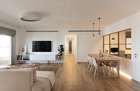 Minimalist living room with dining area, light wooden floors, and modern furniture.