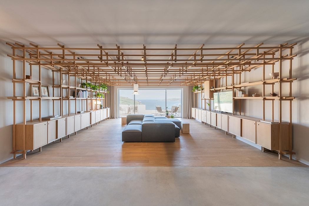 Spacious room with modular wooden shelving units, large windows, and modern furniture.
