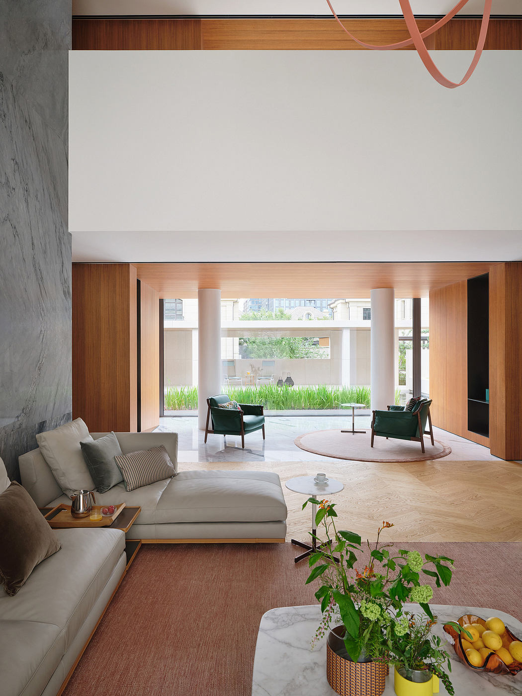 Spacious modern interior with clean lines, natural materials, and integrated greenery.