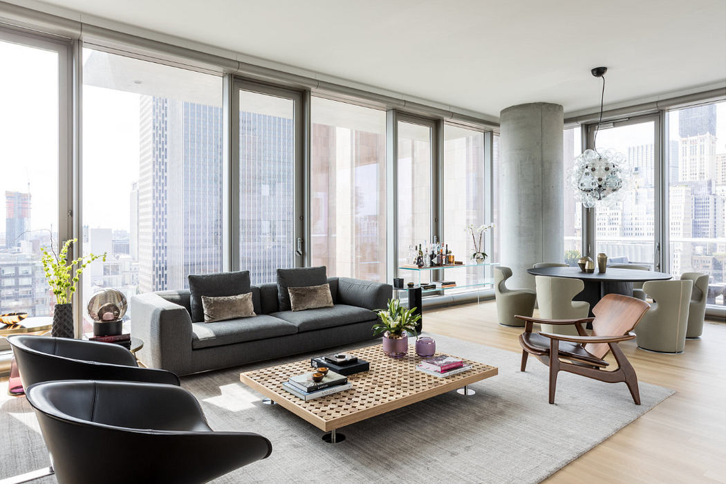 Sleek high-rise living room with large windows and city view.