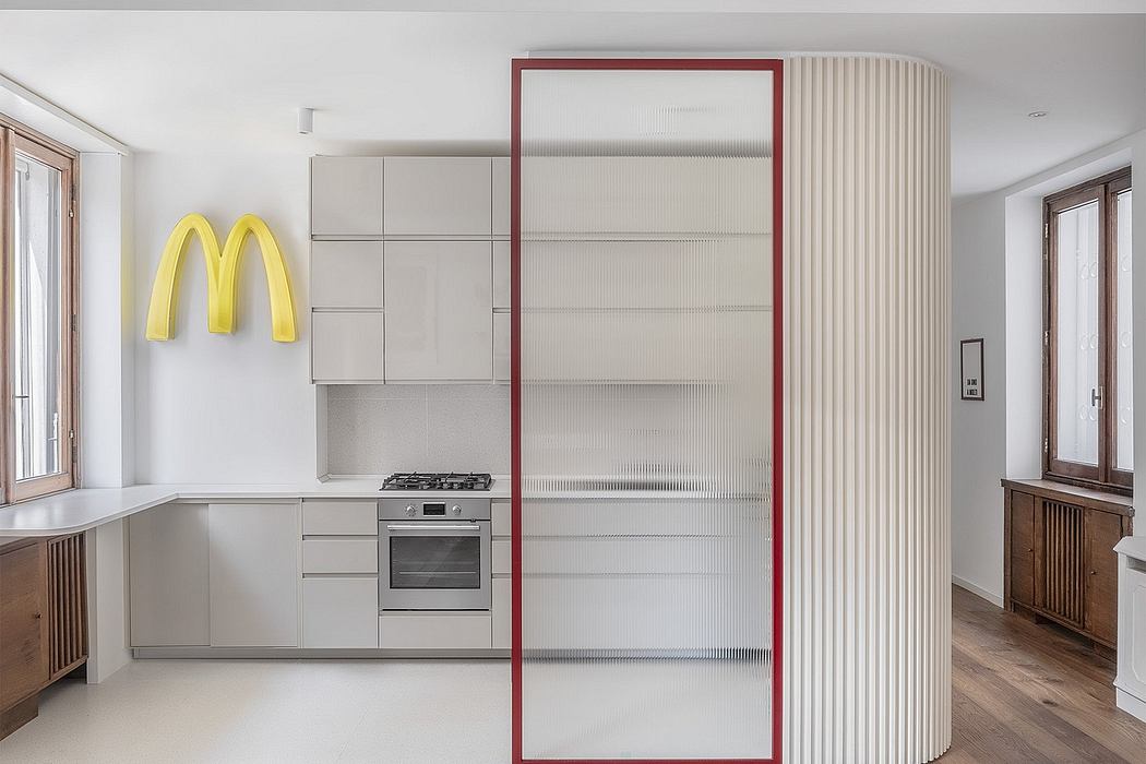 Modern kitchen interior with minimalist design and a McDonald's logo on the wall.