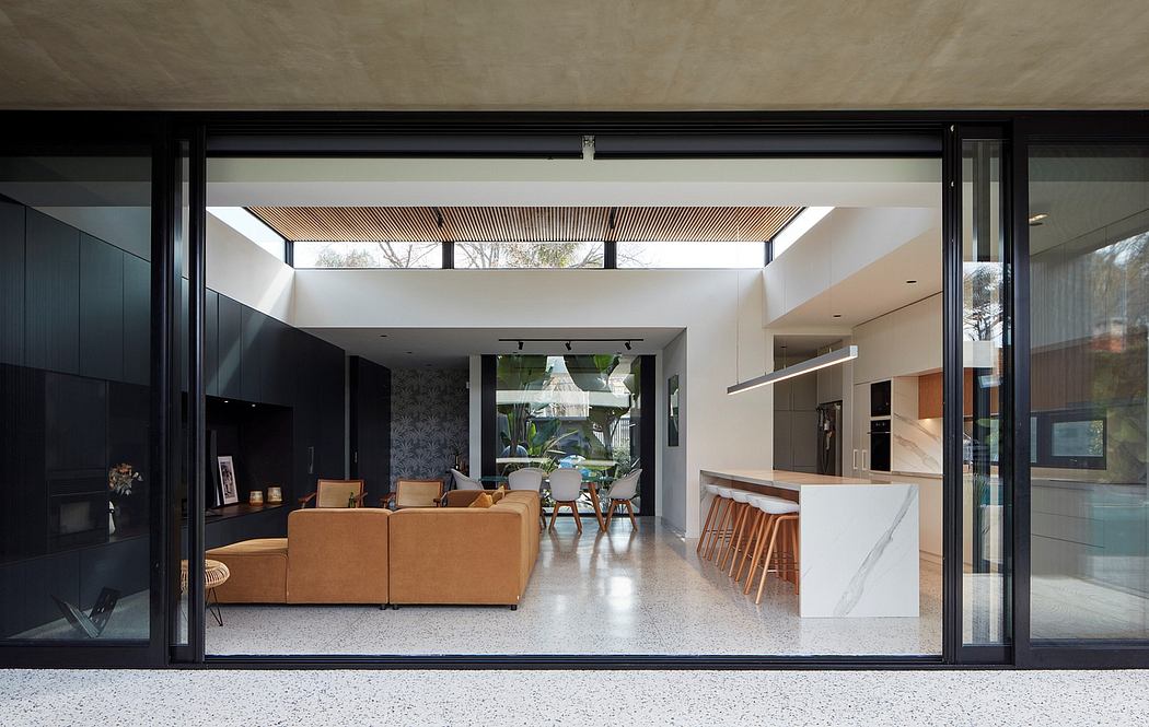 Modern home interior with open-plan design, large windows, and minimalist furniture.