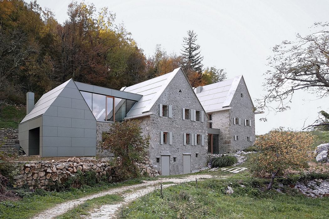 A contemporary building with stone and metal facade, complementing the surrounding nature.