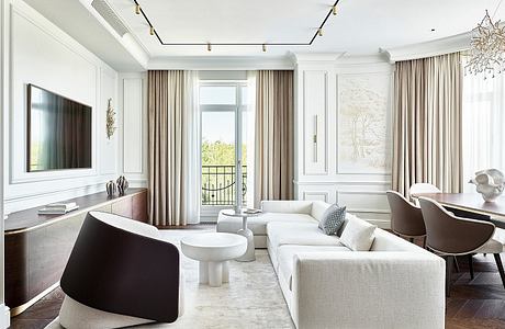 Elegant living room with recessed lighting, modern furnishings, and French doors leading to a balcony.