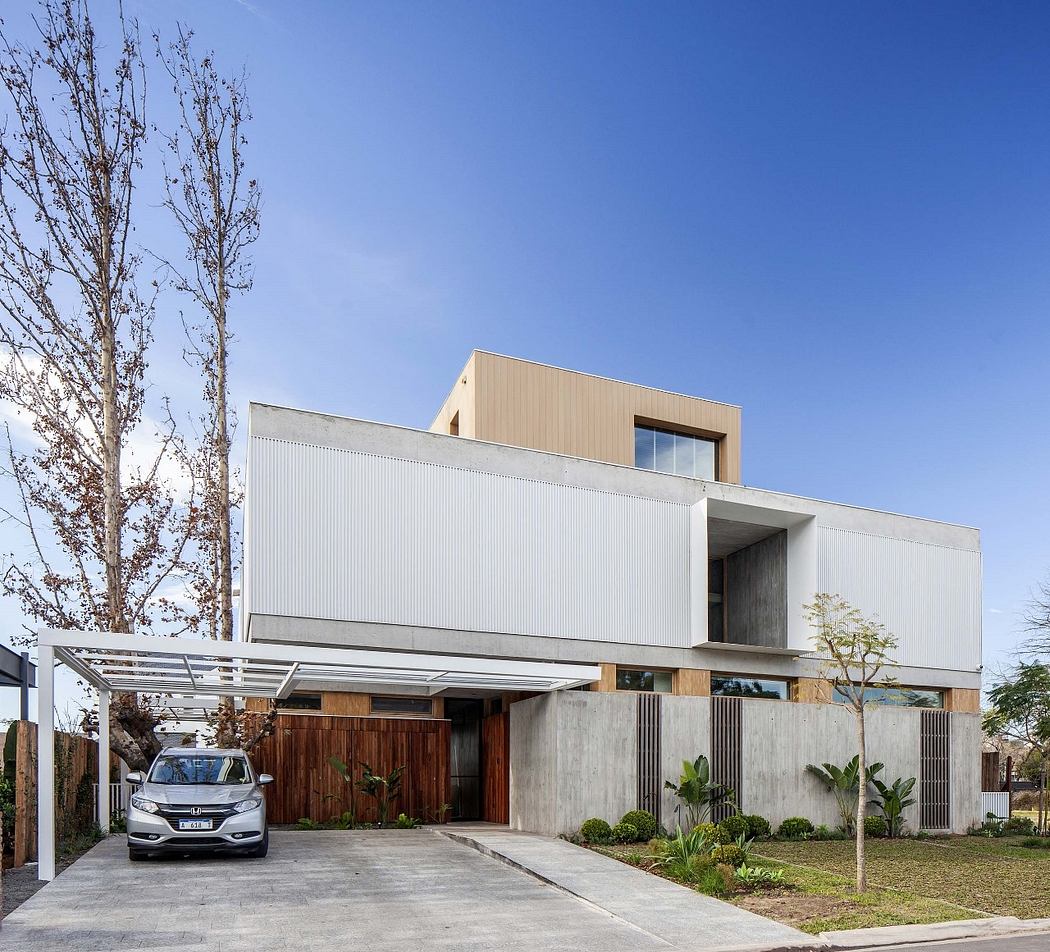 Modern two-story house with geometric design, wood accents, and car parked outside.