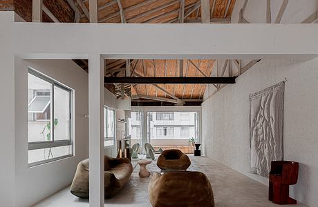 Industrial-style loft with exposed beams and minimalist decor.