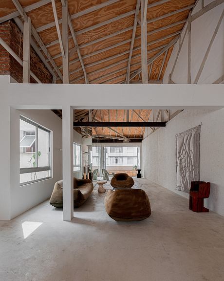 Industrial-style loft with exposed beams and minimalist decor.