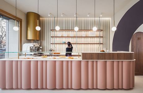 Chic café interior with pleated counter and vertical wood slats