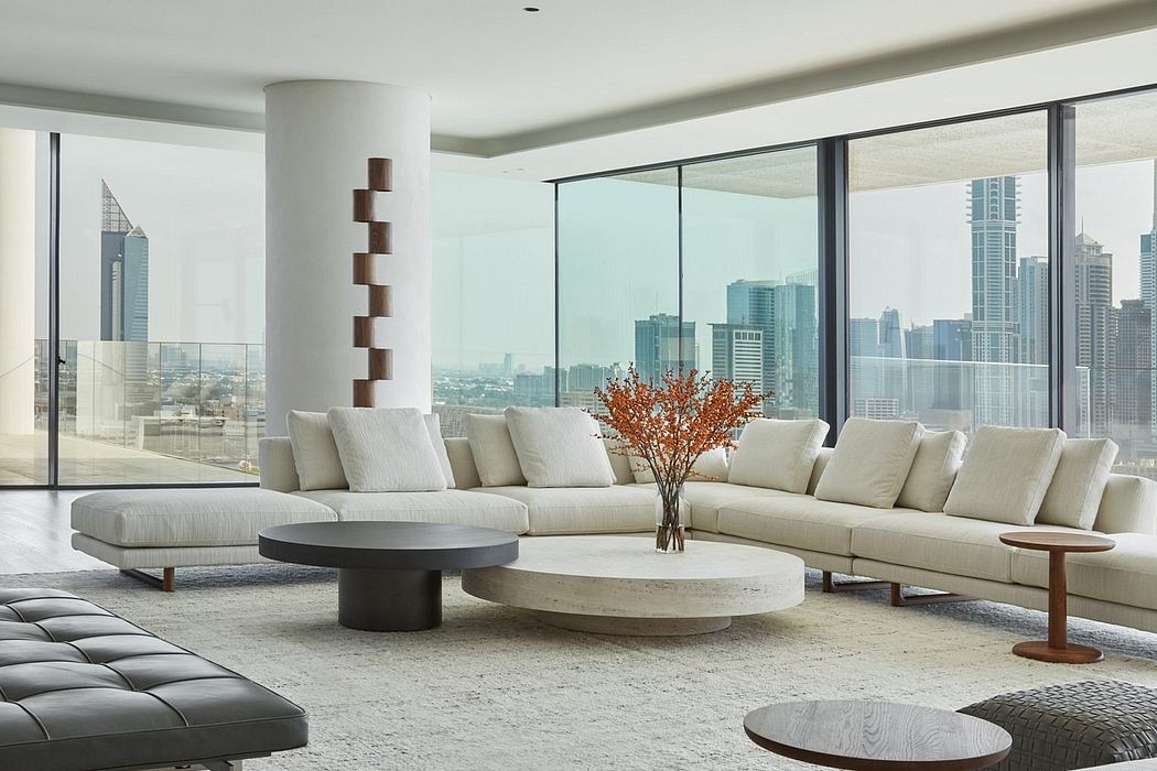Spacious modern living room with sleek furniture, floor-to-ceiling windows, and a cityscape view.