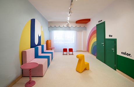 A vibrant, whimsical interior with bold geometric patterns, color-blocking, and playful furniture.