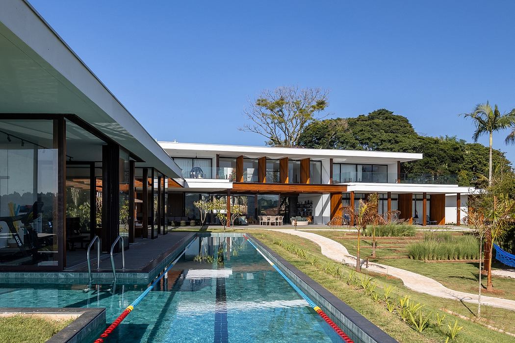 Modern house with large windows, a flat roof, and a long pool in the