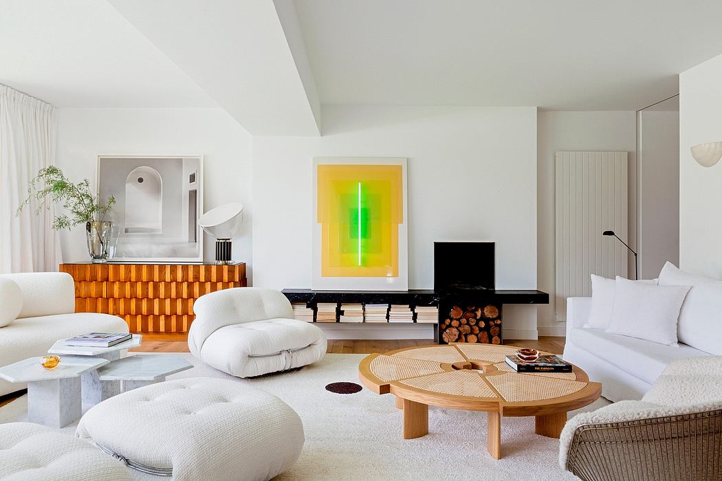 Minimalist living room with sleek white furniture, statement lighting, and warm wood accents.