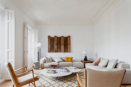 Elegant living room with classic moldings and contemporary furniture.