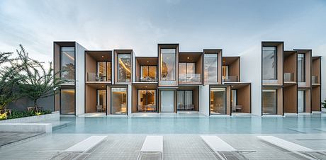 Contemporary house with large glass windows and a pool.