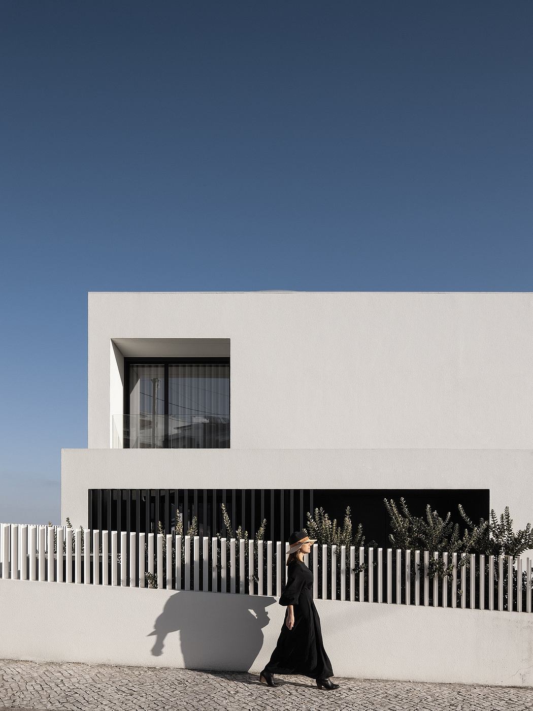 Modern minimalist building exterior with contrasting black and white elements, creating an intriguing visual composition.