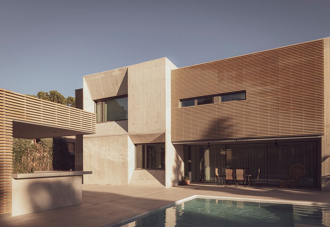 Modern house with geometric design and pool at dusk.