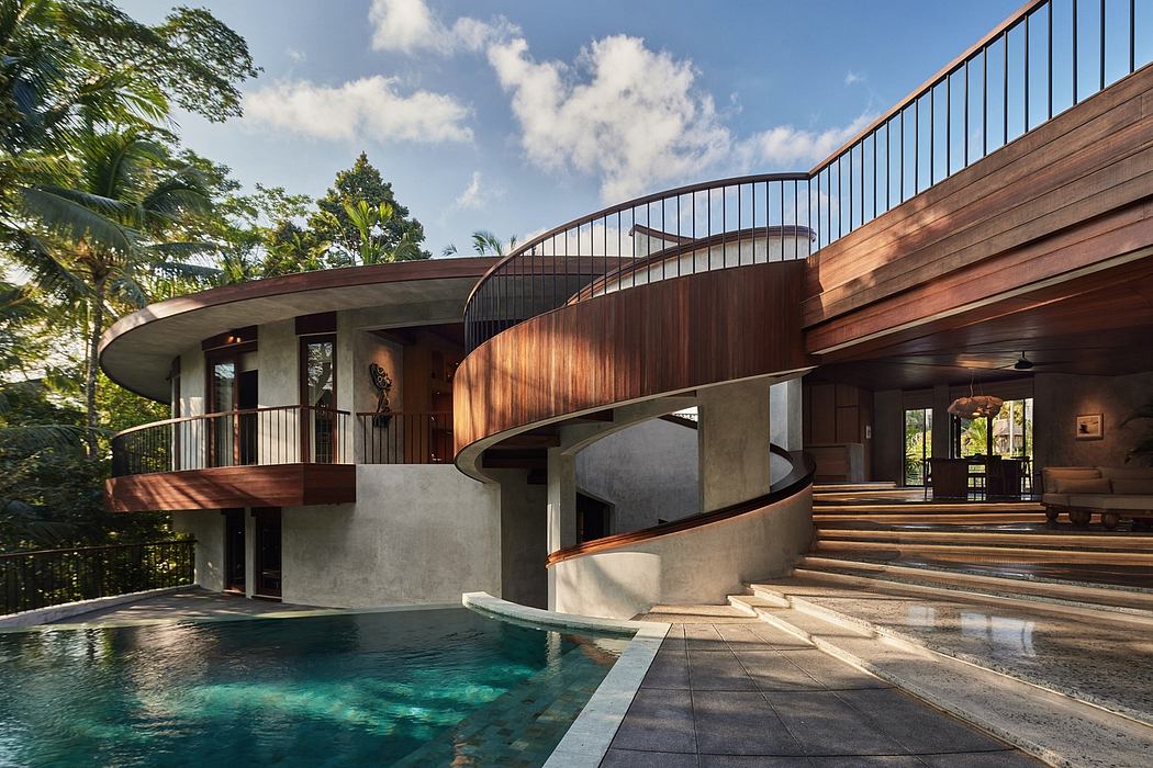 A modern tropical villa with a curved wooden facade, stairs leading to a swimming pool.