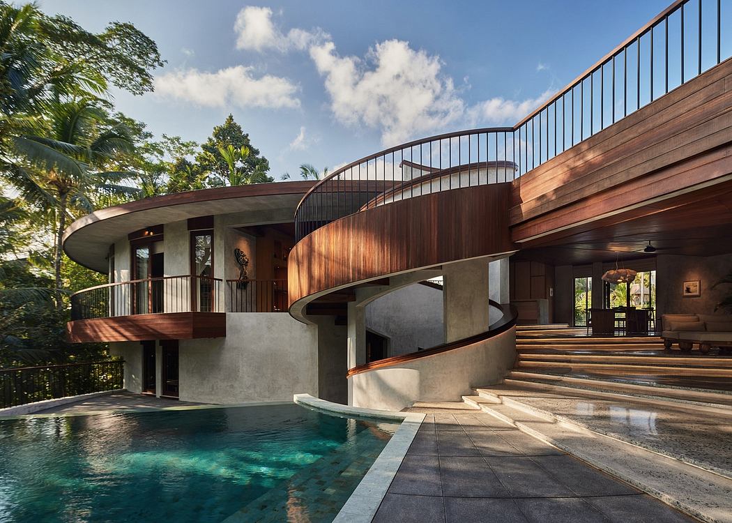 A modern tropical villa with a curved wooden facade, stairs leading to a swimming pool.