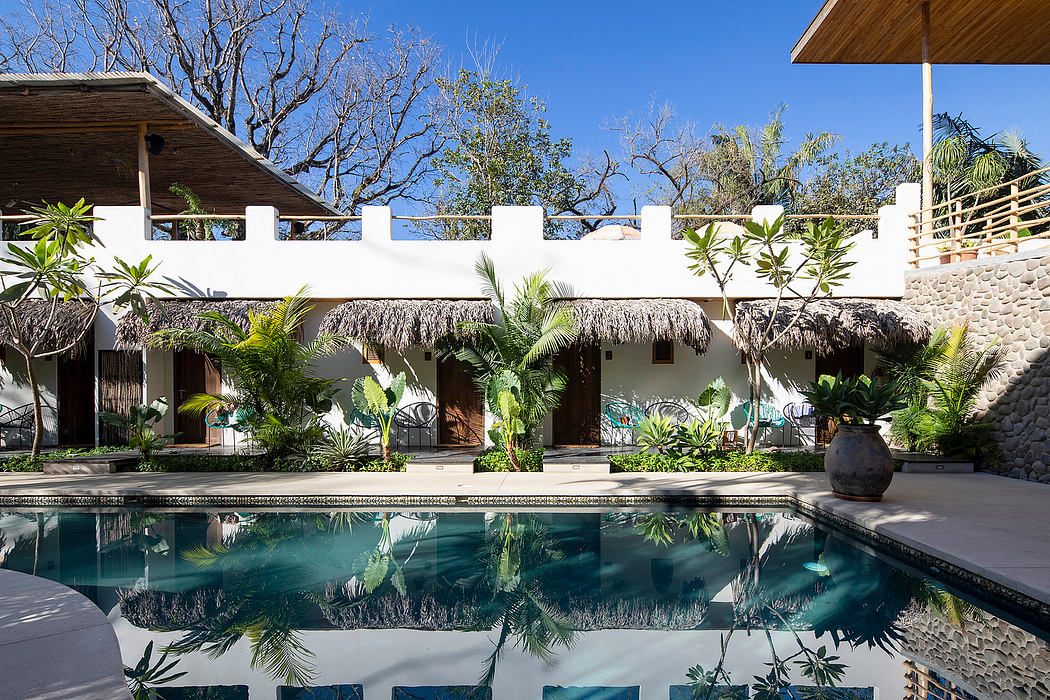 A tropical resort-style backyard with a pool and thatched-roof cabanas.