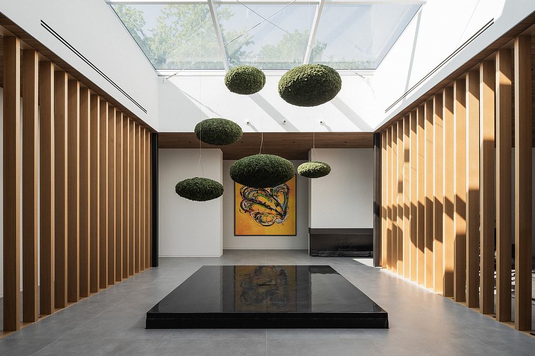 Minimalist interior design with suspended moss spheres, wood paneling, and large artwork.