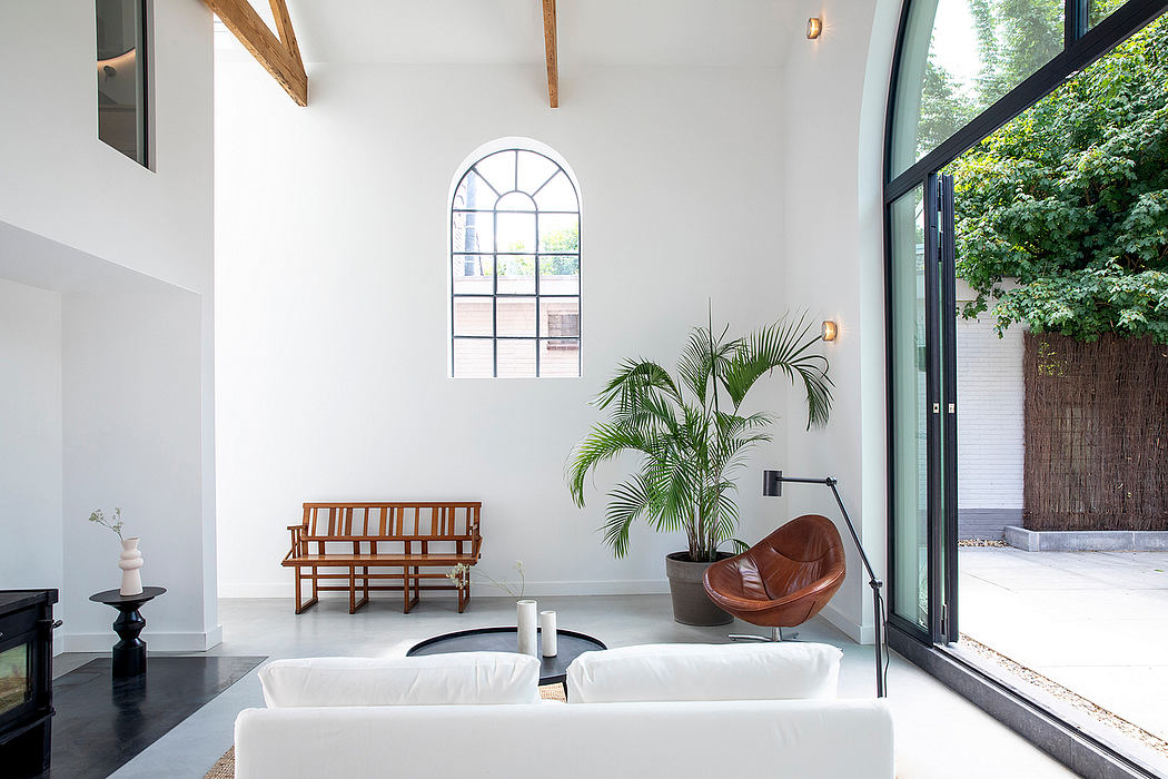 Bright, airy space with arched window, wooden beams, and modern furnishings.