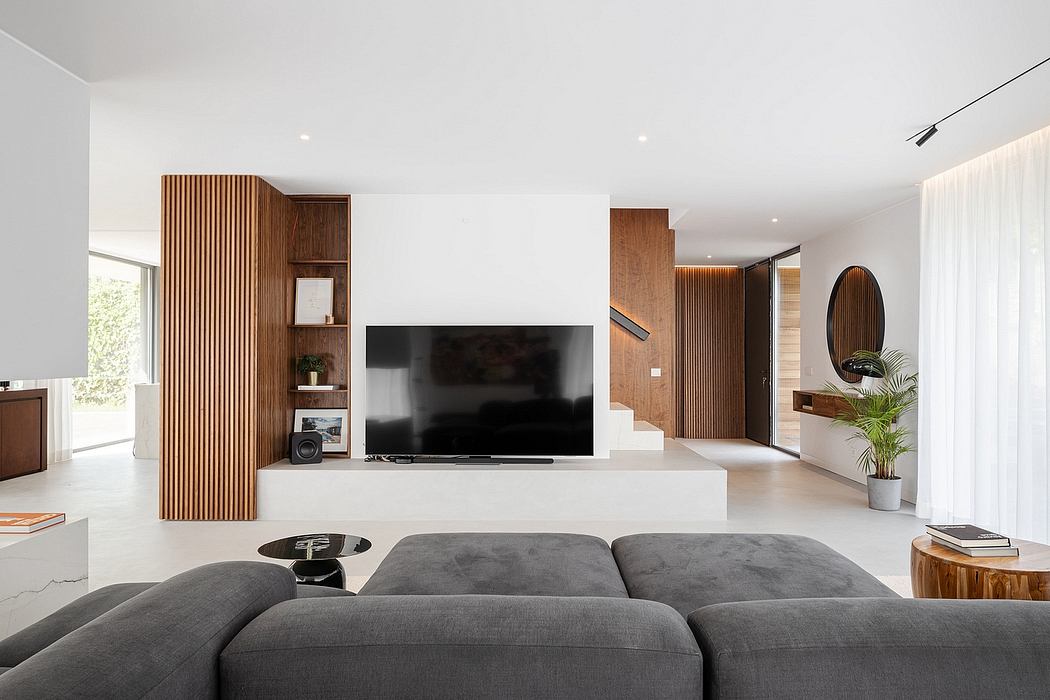 Modern living room with sleek furniture and wooden accents.