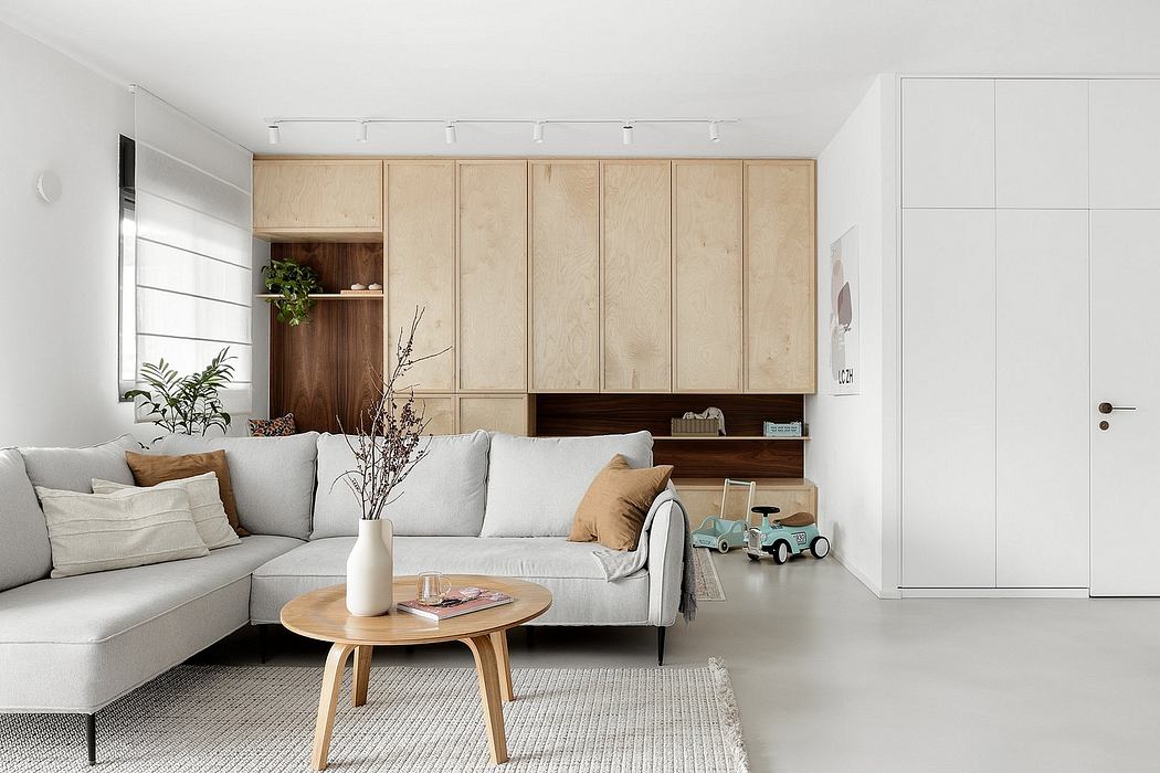 Minimalist living room with wooden cabinets and neutral tones.