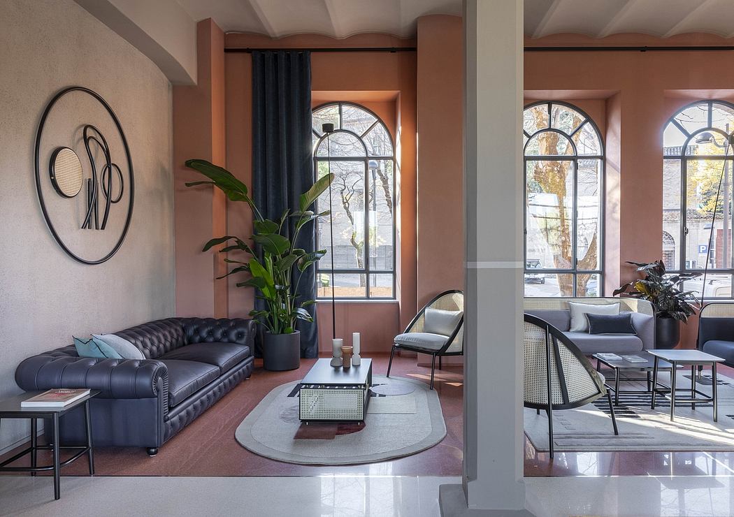 Spacious, modern living room with large windows, plush leather sofa, and stylish decor.