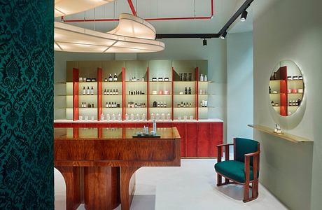 Sleek, modern bar design with wooden accents, red shelving, and curved overhead lighting.