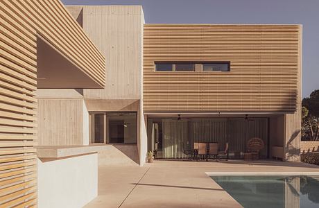 Contemporary house with wooden slats and pool.