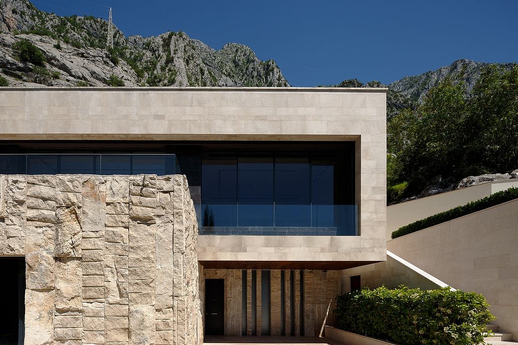 Distinctive stone facade, sleek glass windows, and inviting entry point create modern aesthetic.