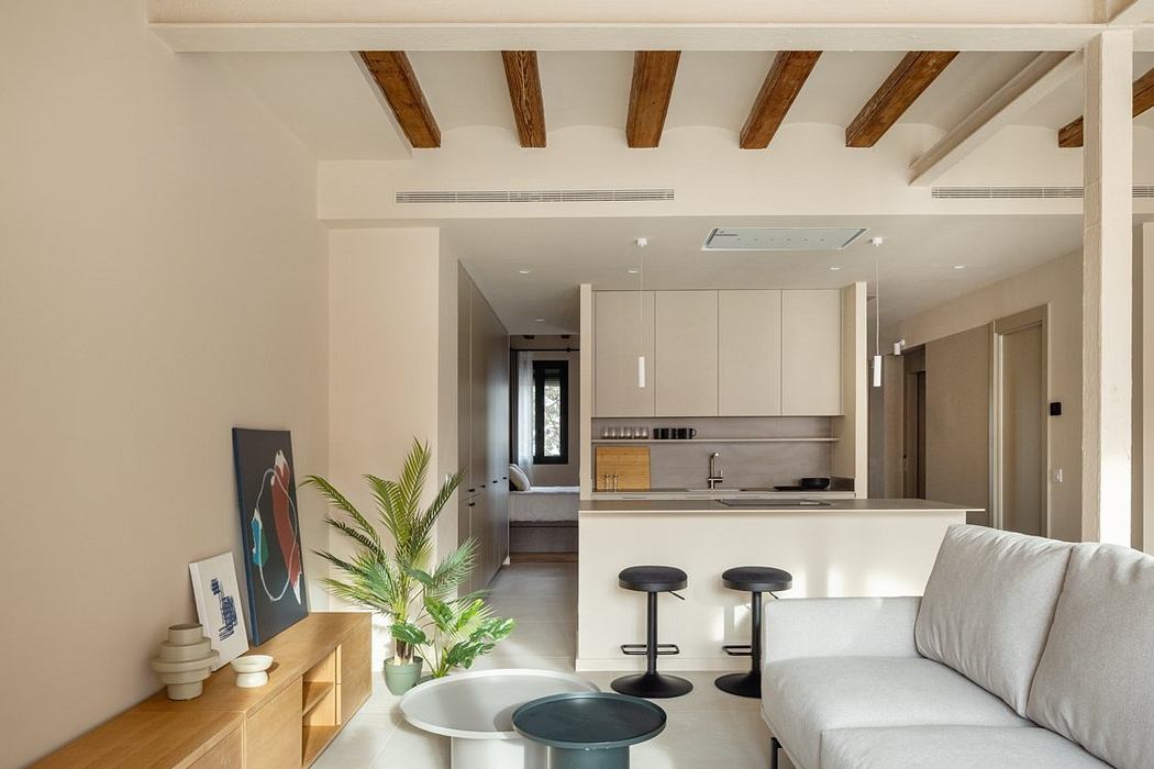 Neutral-toned contemporary living space with exposed wooden beams and modern furniture.
