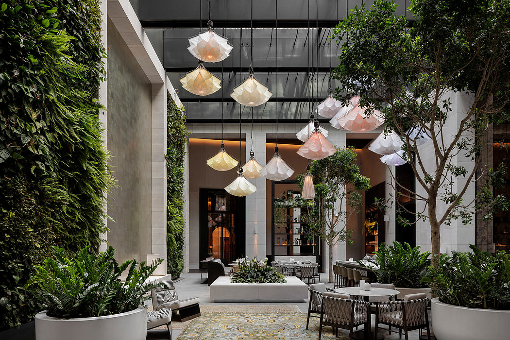 Elegant indoor garden with pendant lights, lush greenery, and contemporary furnishings.